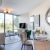 living room with couch chairs floor to ceiling windows and tv Pinnacle NoMa luxury apartments in DC