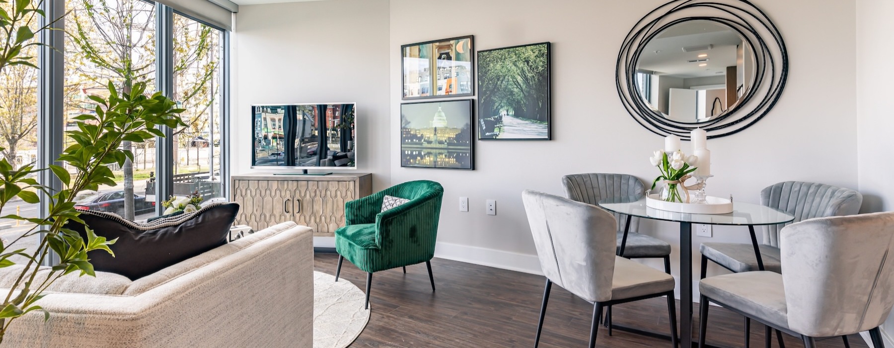 a living room with a couch, tv, tables and chairs