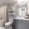 Brightly lit bathroom with large vanity inside Pinnacle Apartments
