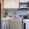 Cozy kitchen with white cabinetry inside Pinnacle Apartments