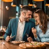 a man and woman eating pizza - Pinnacle NoMa DC brand new apartments